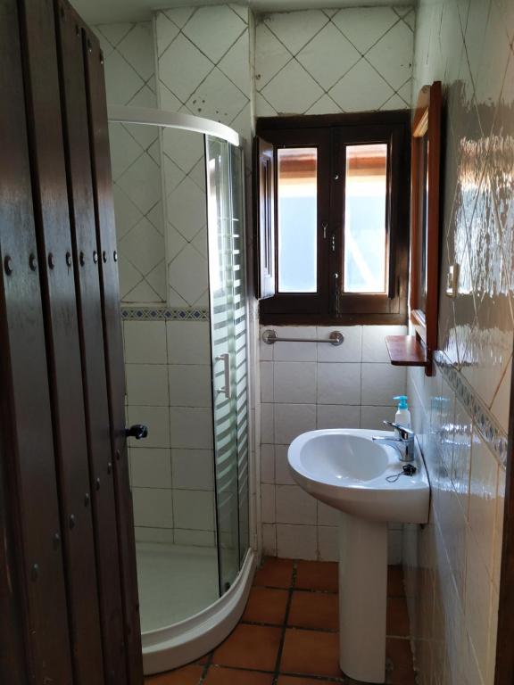 a bathroom with a sink and a shower at Cortijo La Solana in Güéjar-Sierra