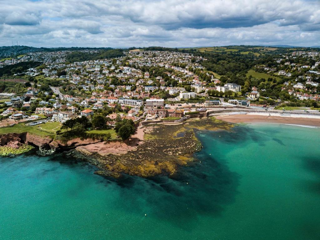 an aerial view of a city and a beach at Livermead Cliff Hotel in Torquay