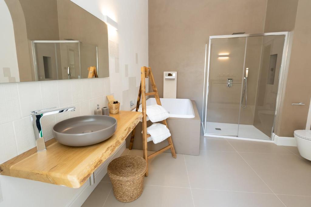 a bathroom with a sink and a toilet and a shower at Corte Sant'Angelo in Monopoli