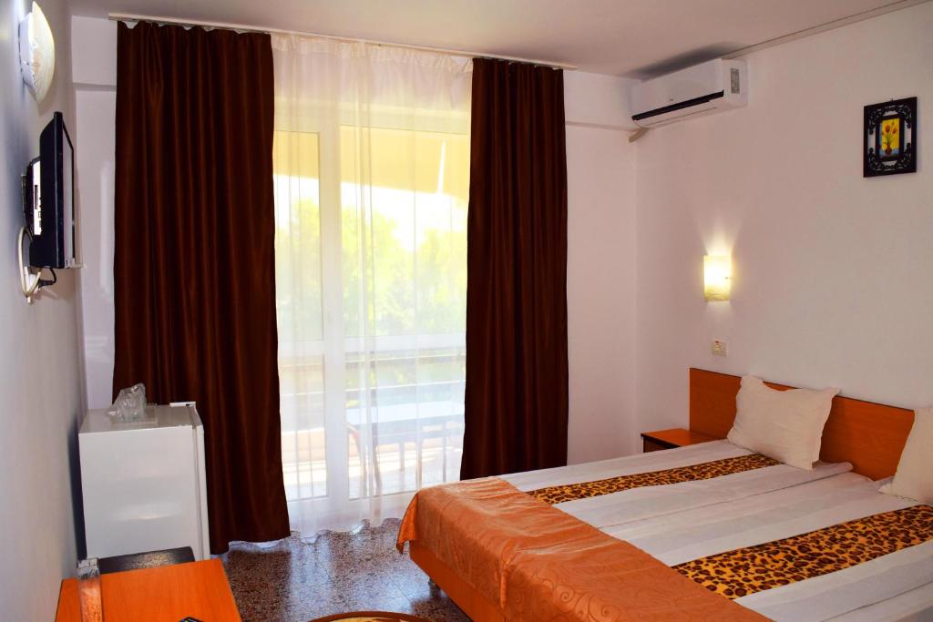 Postel nebo postele na pokoji v ubytování Hotel Sanda