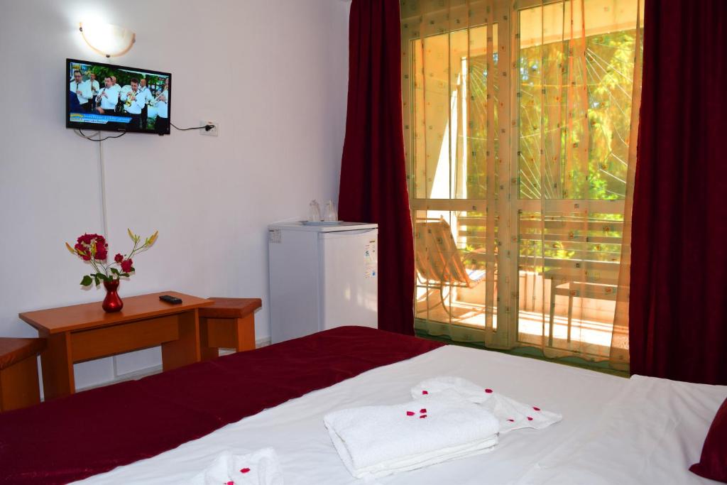 Postel nebo postele na pokoji v ubytování Hotel Sanda