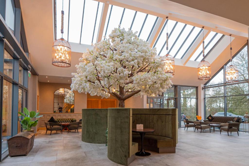 a large tree in the middle of a lobby at Enterkine Country House Resort in Annbank