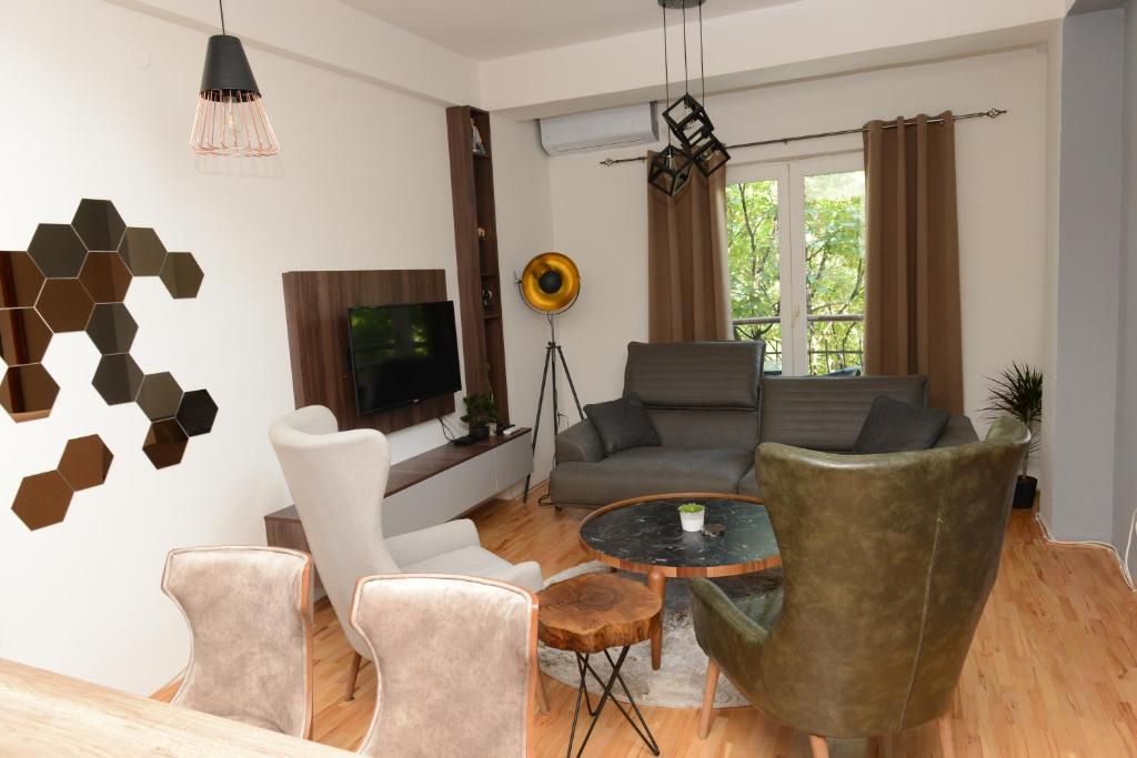 a living room with a couch and a table and chairs at Central Pearl Apartment in Ohrid