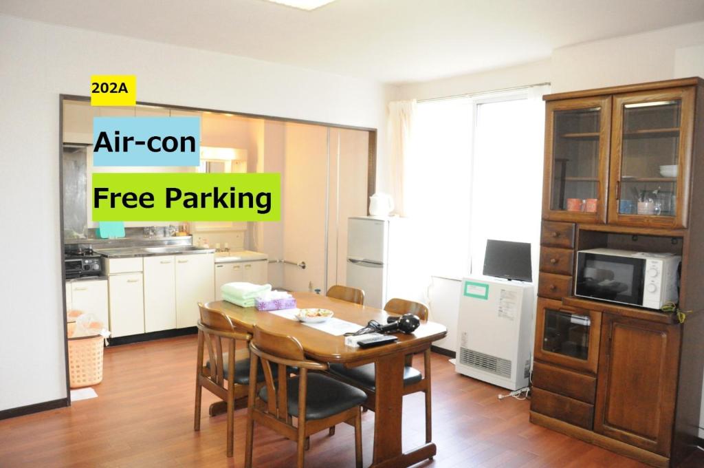 a kitchen with a table and chairs in a room at Ark City Asahikawa - Vacation STAY 8523 in Asahikawa
