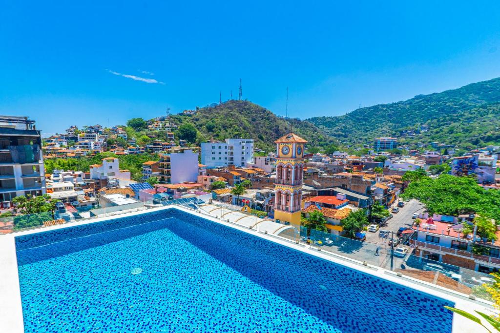a view of a city with a swimming pool at Tres Marias Luxury Suites - Adults Only in Puerto Vallarta