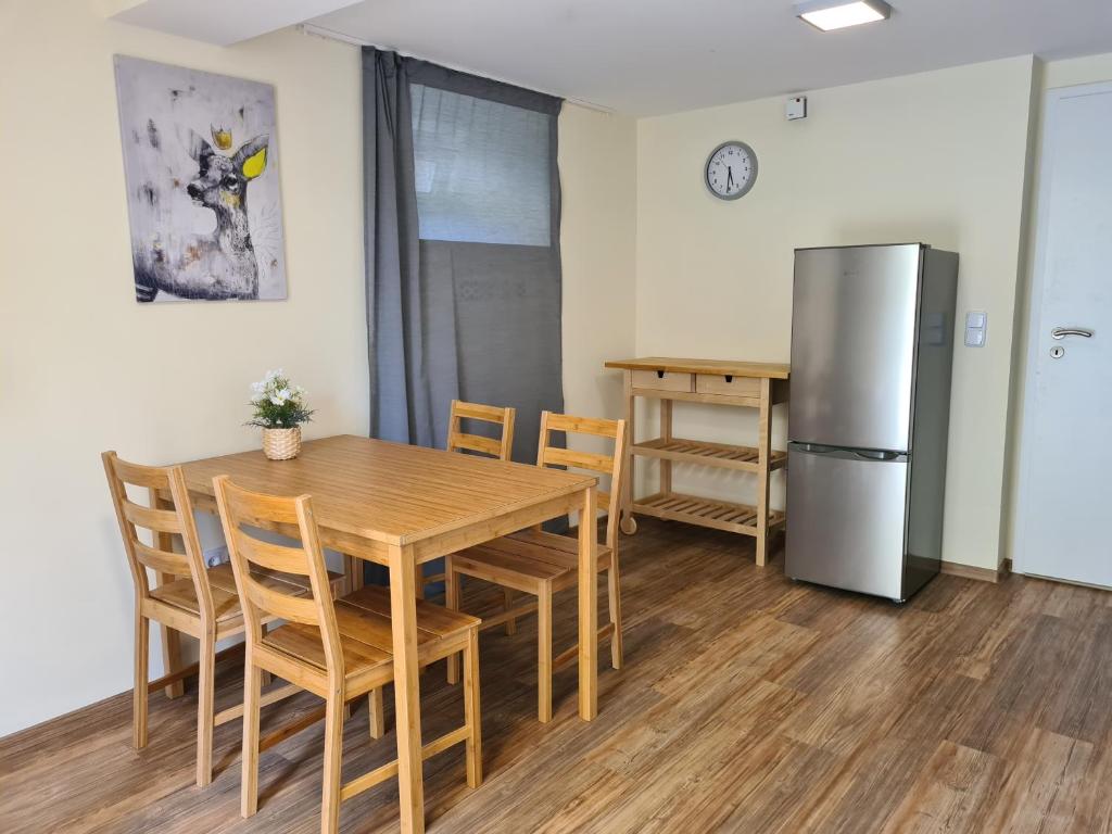 a kitchen and dining room with a table and refrigerator at Kamus in Baden-Baden