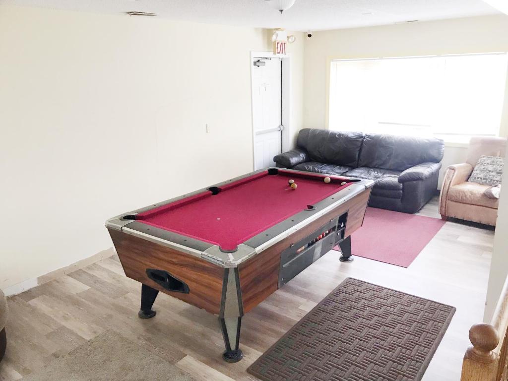 a living room with a pool table in it at 1950s Charm In The Heart Of Waterbury in Waterbury
