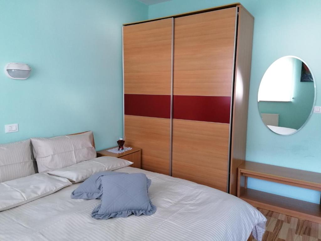 a bedroom with a bed and a large closet at Apartment Modrina in Kobarid