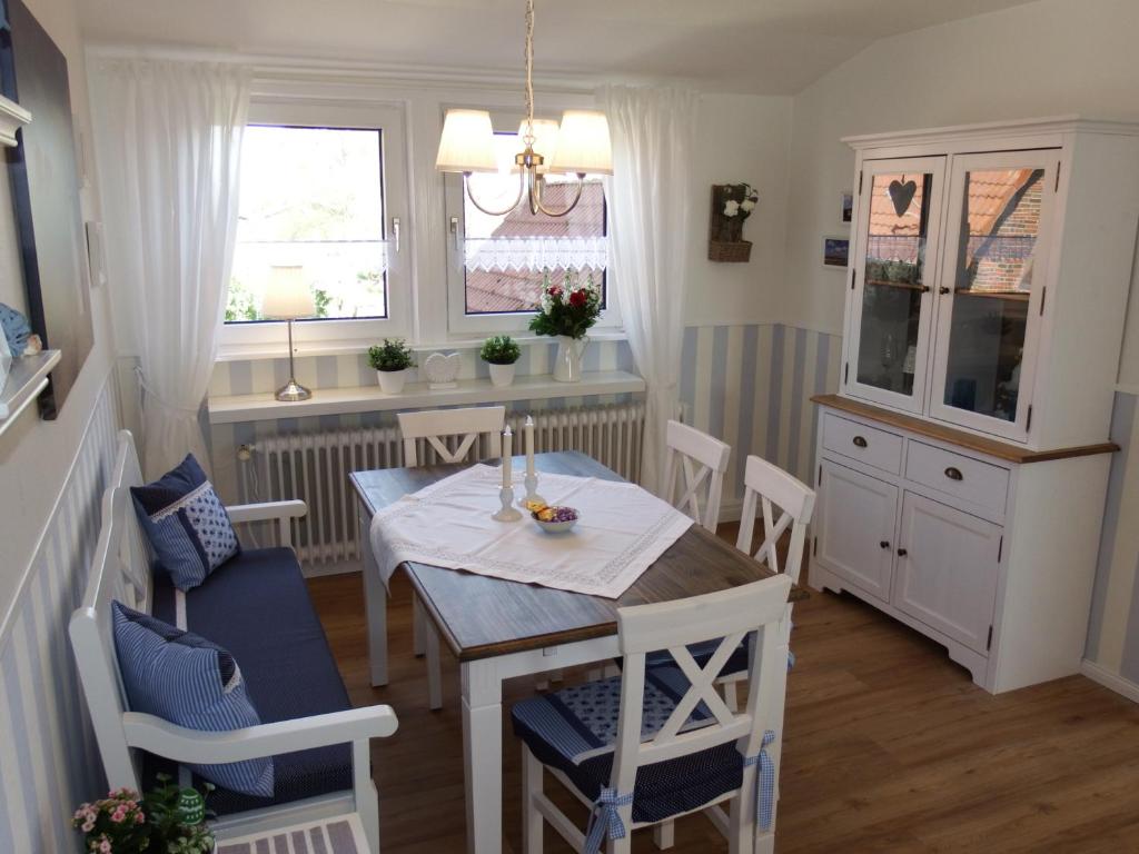 cocina y comedor con mesa y sillas en Ferienwohnung Seestern, en Wangerland