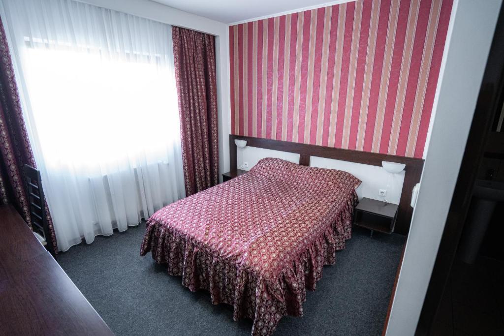 Postel nebo postele na pokoji v ubytování Hotel Polaris
