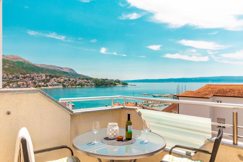 a balcony with a table and a view of the water at Apartments LaCaleta in Split