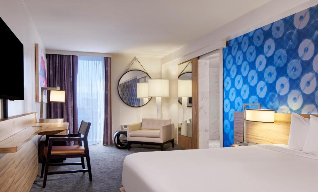 a hotel room with a bed and a desk and a chair at The LINQ Hotel and Casino in Las Vegas