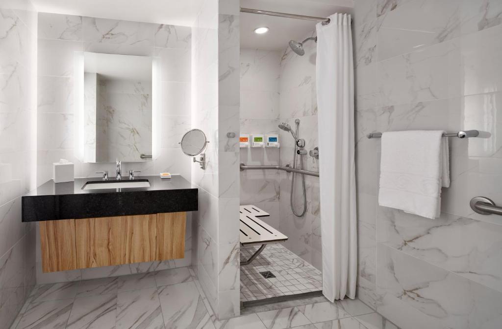a bathroom with a sink and a shower at The LINQ Hotel and Casino in Las Vegas