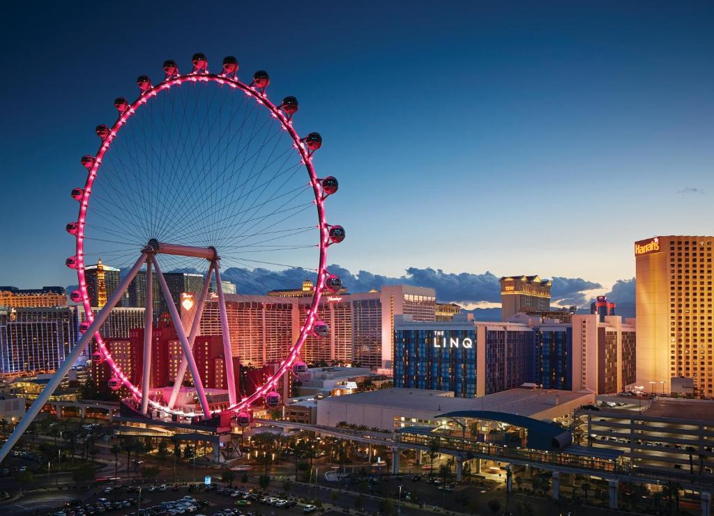 a ferris wheel in a city at night at The LINQ Hotel and Casino in Las Vegas