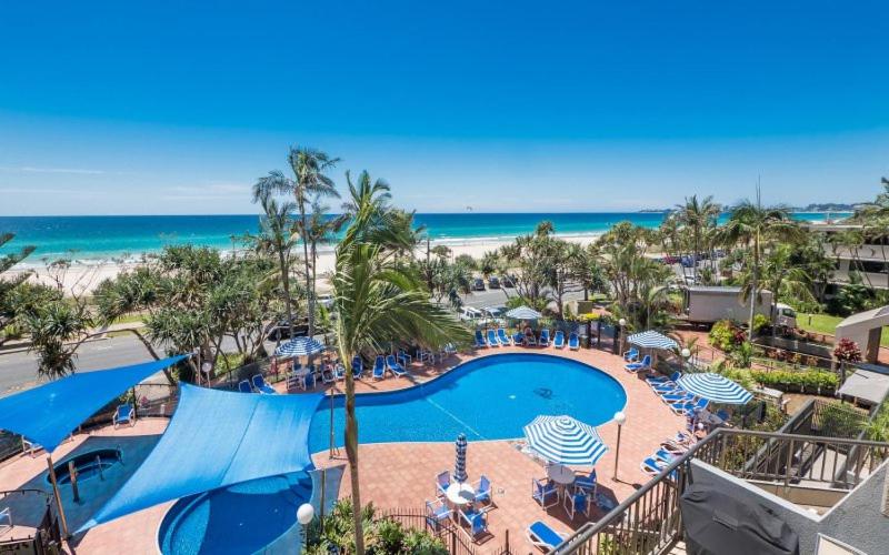 an aerial view of a resort with a swimming pool and the beach at The Rocks Resort - Official in Gold Coast