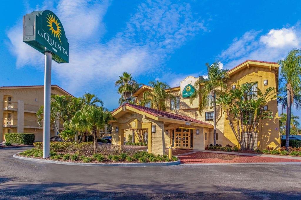 a hotel with a street sign in front of it at La Quinta Inn by Wyndham Tampa Bay Pinellas Park Clearwater in Pinellas Park