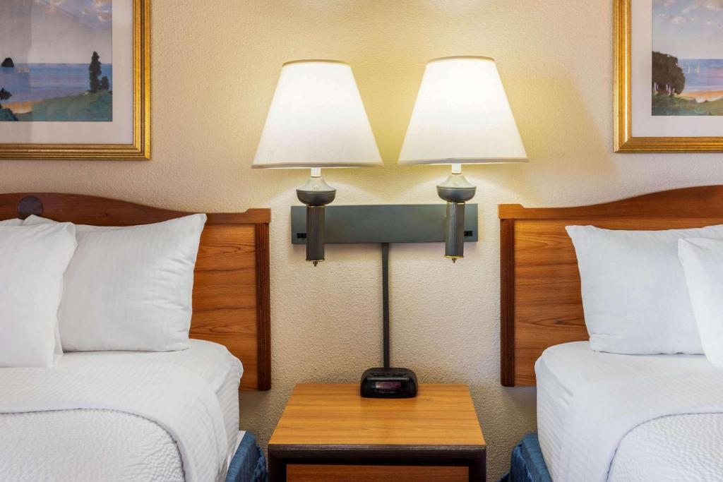a hotel room with two beds and a table with two lamps at La Quinta Inn & Suites by Wyndham Las Cruces Organ Mountain in Las Cruces