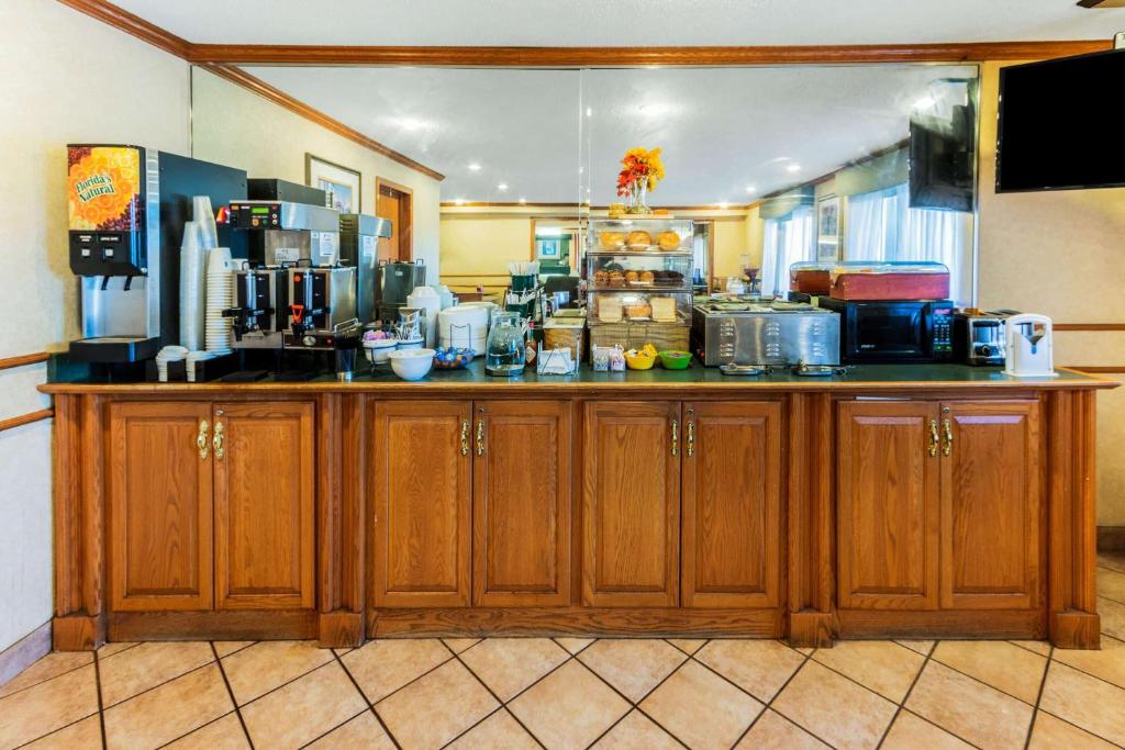 a kitchen with wooden cabinets and a counter top at La Quinta Inn & Suites by Wyndham Las Cruces Organ Mountain in Las Cruces