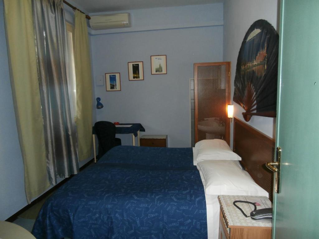 Postel nebo postele na pokoji v ubytování Albergo Junior