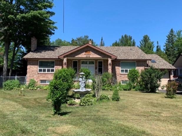 a brick house with a fountain in a yard at Leslie in Wasaga Beach