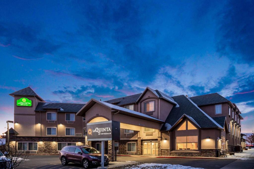 a building with a car parked in front of it at La Quinta by Wyndham Bozeman in Bozeman