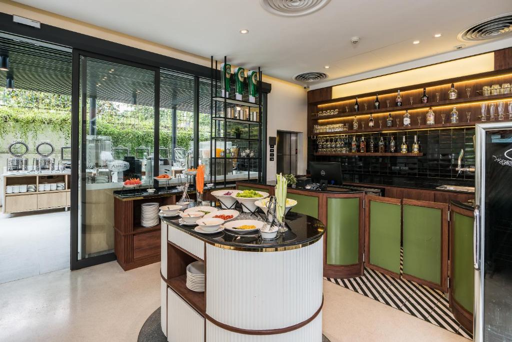 a kitchen with a counter with dishes on it at Hotel Amber Sukhumvit 85 in Bangkok