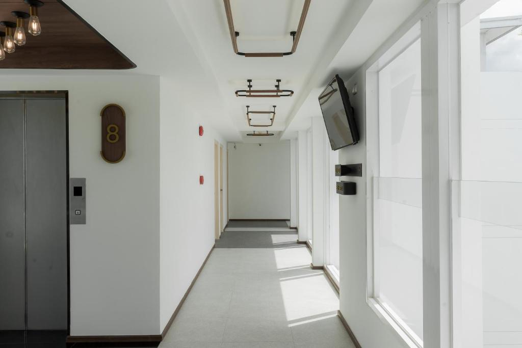 a corridor in a building with white walls at Hotel Amber Sukhumvit 85 in Bangkok