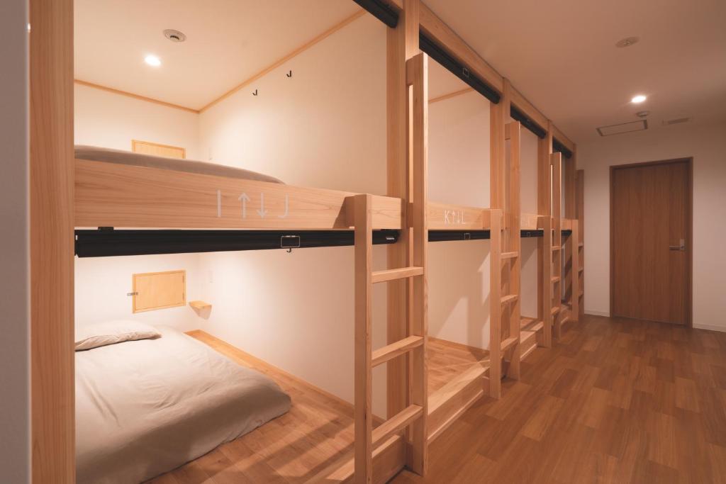 a dorm room with bunk beds in it at THY GUEST HOUSE in Ise