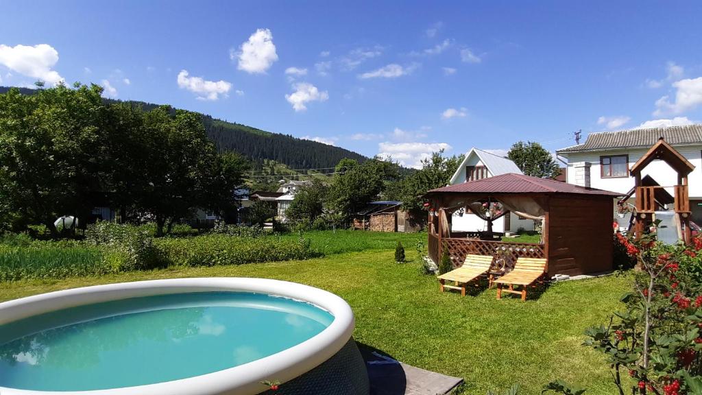 a backyard with a swimming pool and a gazebo at Lavanda in Verkhovyna