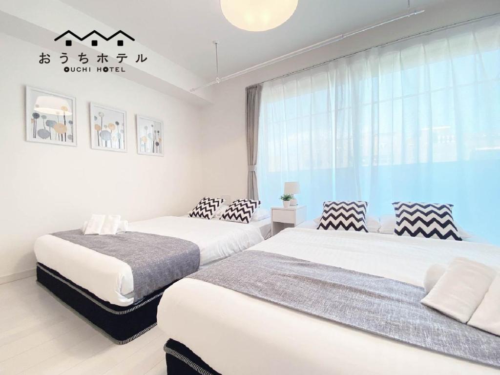 Postel nebo postele na pokoji v ubytování OUCHI HOTEL Miyajimaguchi