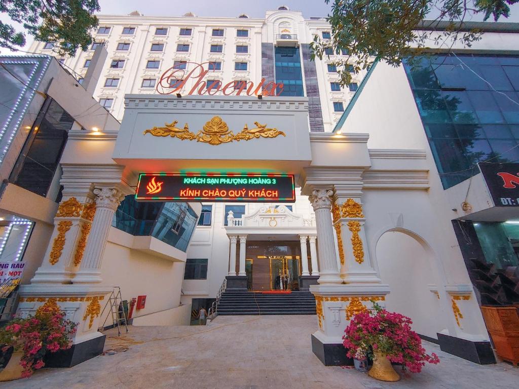 a large white building with a sign in front of it at Khách Sạn Phượng Hoàng 3 in Thanh Hóa