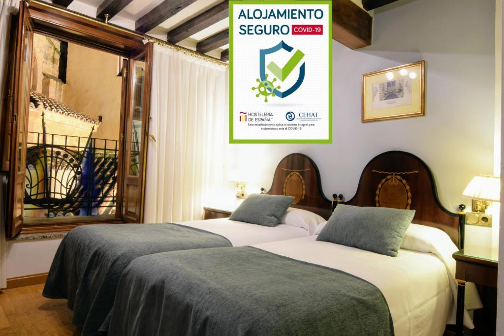 
A bed or beds in a room at Hospedium Plaza Mayor Salamanca
