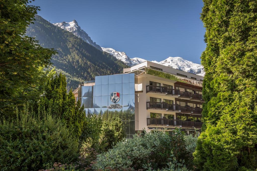 a hotel in the mountains with mountains in the background at Pointe Isabelle in Chamonix