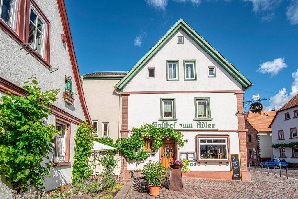 a building in the middle of a street at Adler Landhotel in Buergstadt