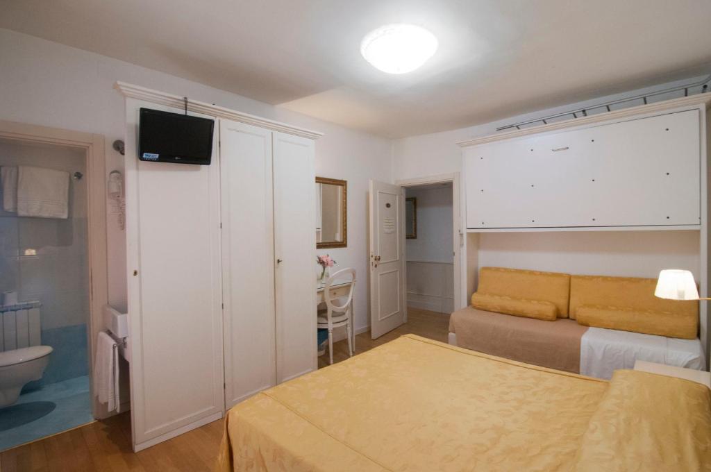 Postel nebo postele na pokoji v ubytování Albergo ai Tolentini