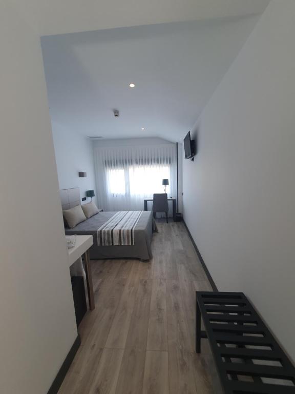 Posteľ alebo postele v izbe v ubytovaní HOTEL IBERUM