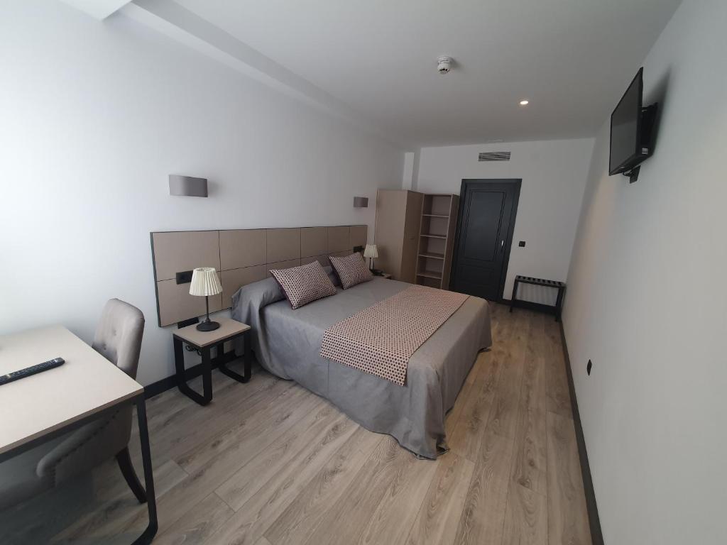 Posteľ alebo postele v izbe v ubytovaní HOTEL IBERUM