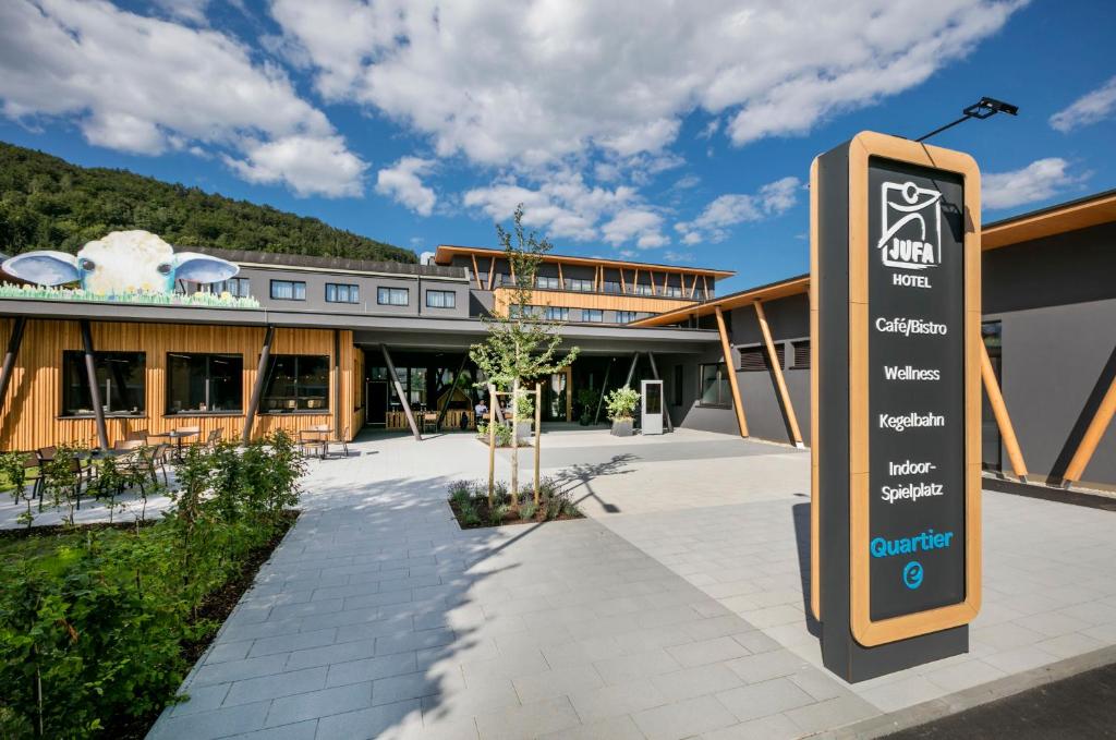 a sign in front of a building at JUFA Hotel Weiz in Weiz