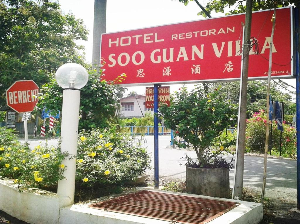 a sign for a hotel restaurant with a stop sign at Soo Guan Villa in Arau