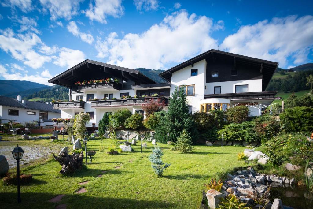 a house in the mountains with a yard at Haus Brandeck in Uttendorf