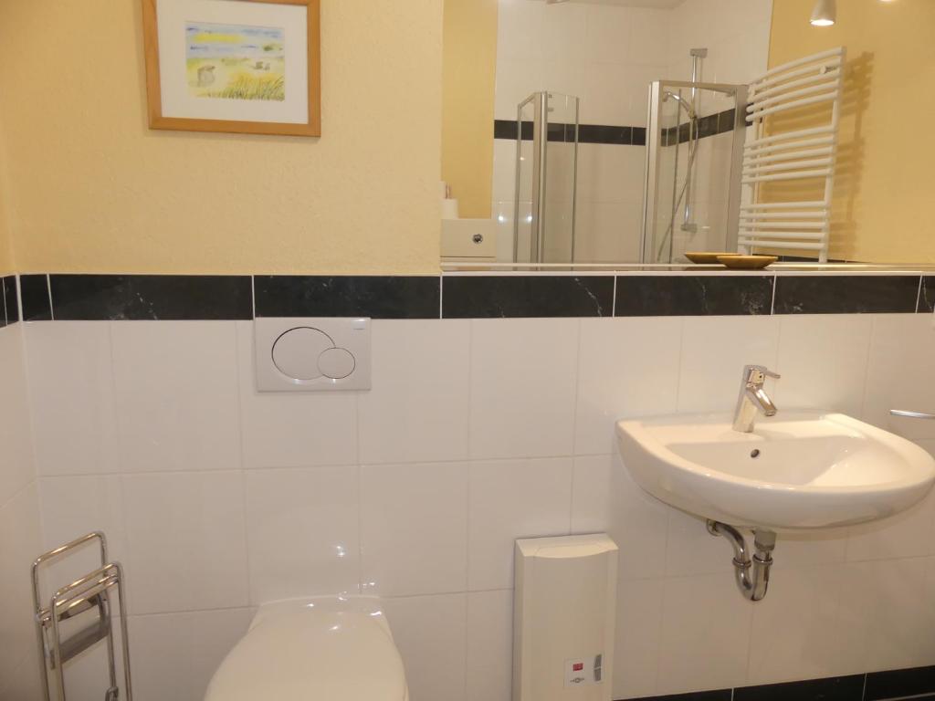 a bathroom with a sink and a toilet at Residenz Prorer Wiek in Binz