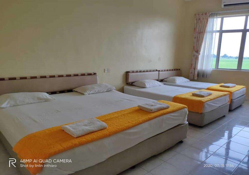 Postel nebo postele na pokoji v ubytování Soo Guan Villa