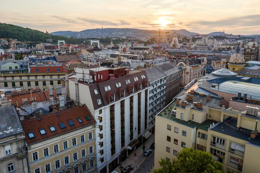 an aerial view of a city at sunset at Danubius Hotel Erzsébet City Center in Budapest