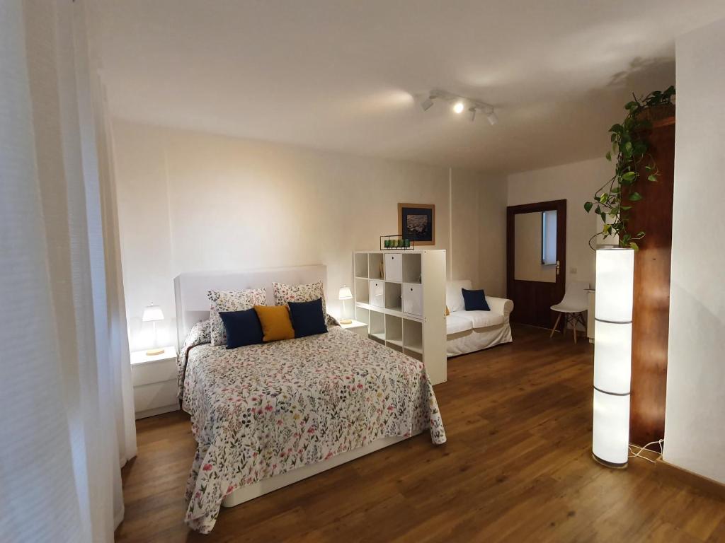 a bedroom with a bed and a living room at La Casita del Reloj in Santa Cruz de la Palma