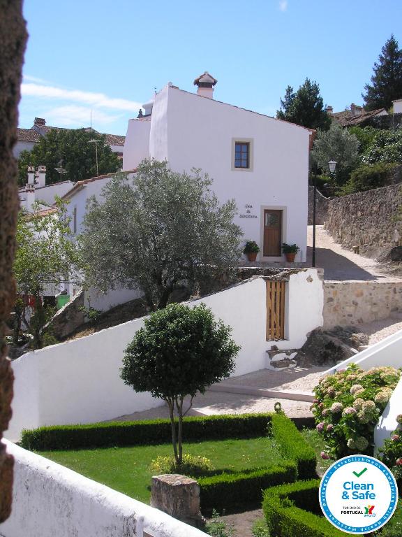 a white house with a tree in front of it at Casa da Silveirinha in Marvão