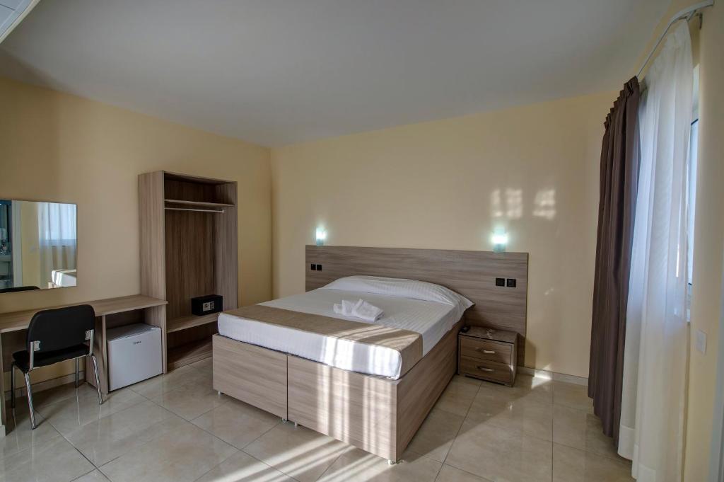 Postel nebo postele na pokoji v ubytování Allegro Hotel