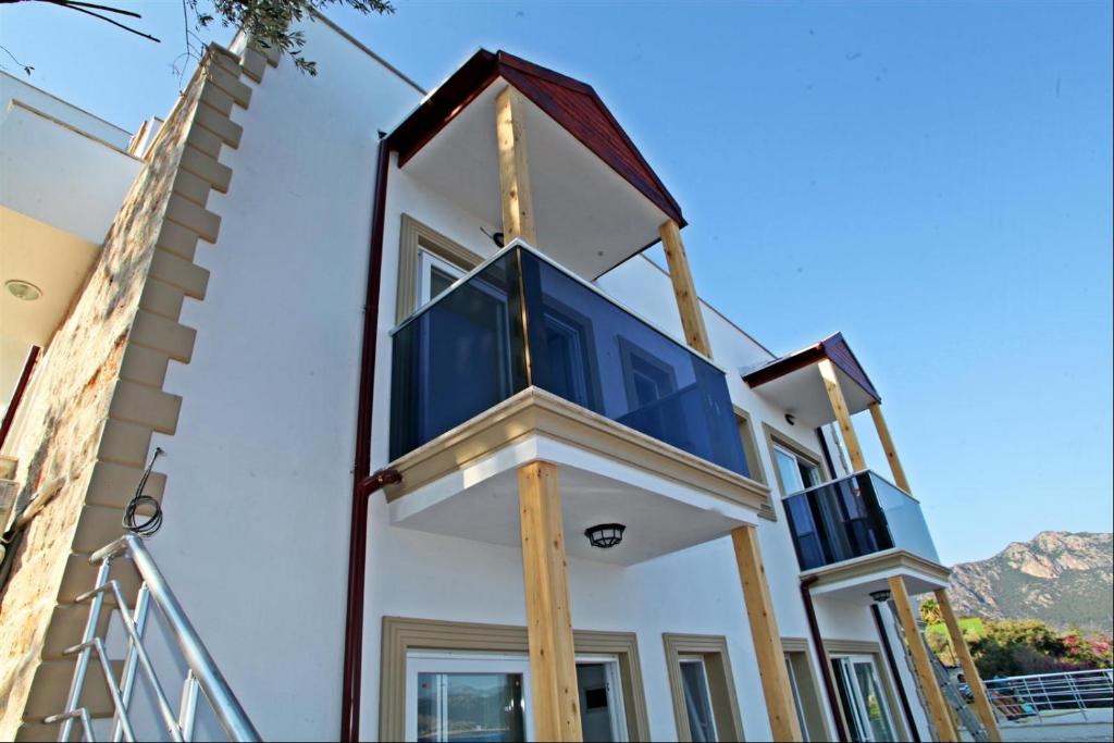 a house with a blue and white at Blue Island Luxury Hotel Adults Only in Kaş