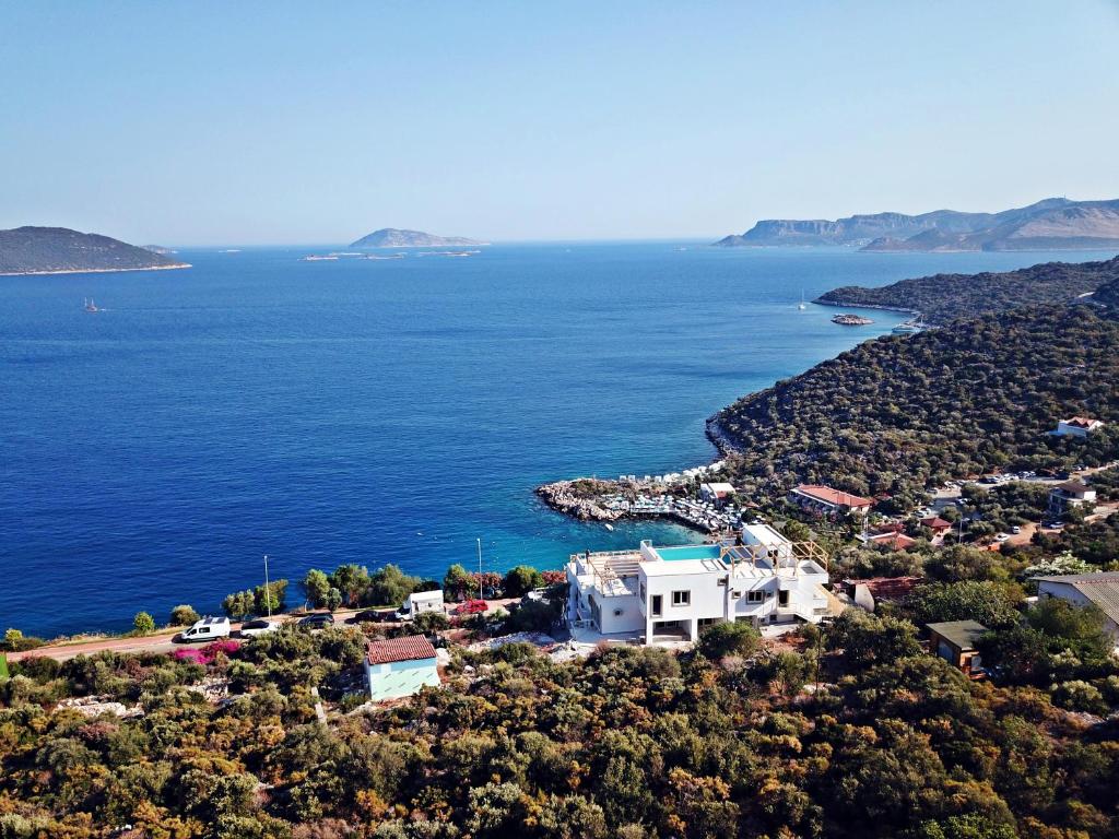 an island with a white house and the ocean at Blue Island Luxury Hotel Adults Only in Kaş
