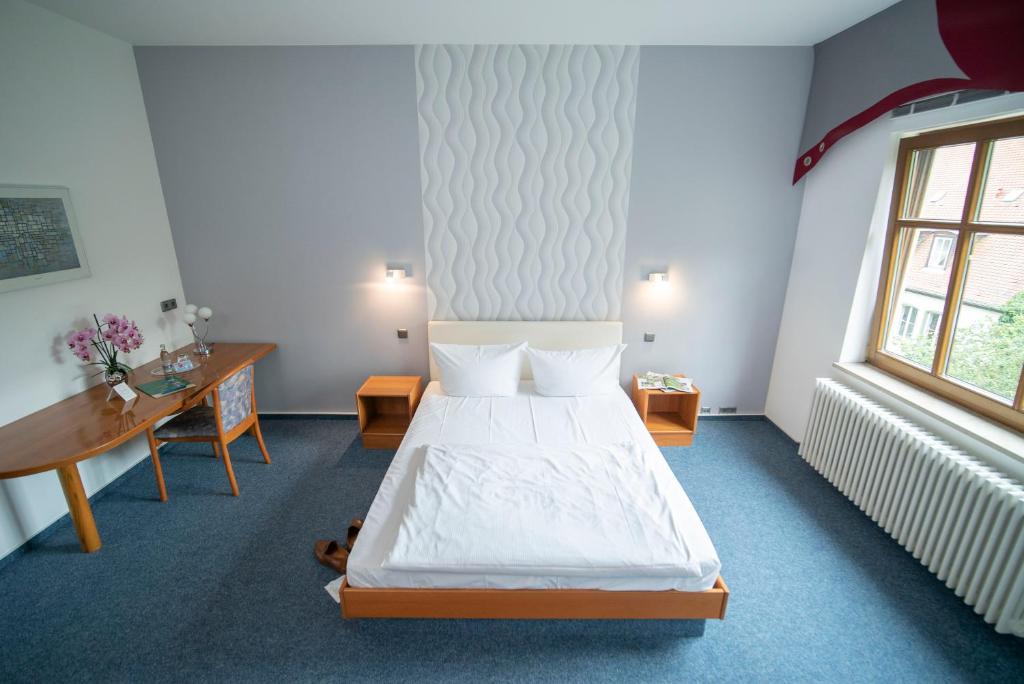 Postel nebo postele na pokoji v ubytování Hotel Liszt