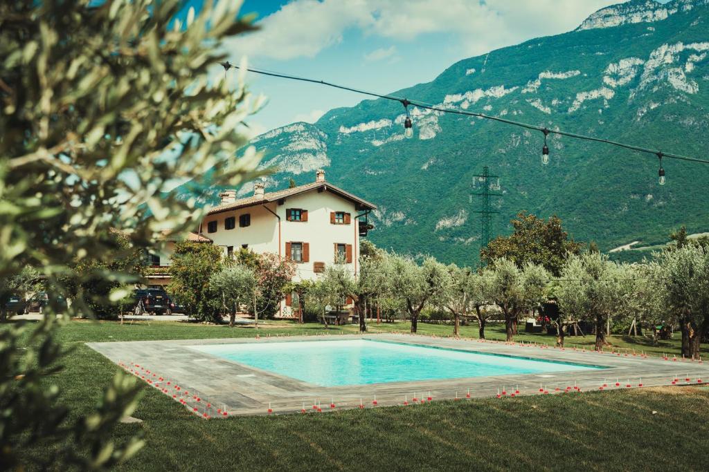 a house and a swimming pool in front of a mountain at Az. Agr. Tenuta La Casetta in Mama